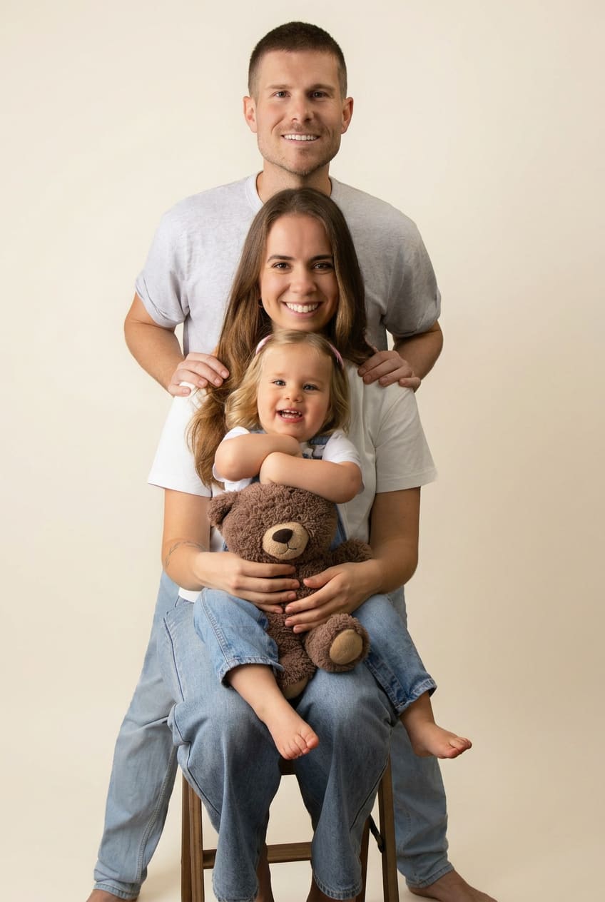Family of five together on a bright studio backdrop in white wardrobe